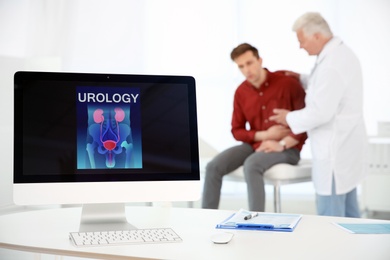 Photo of Computer monitor with word UROLOGY and people on background