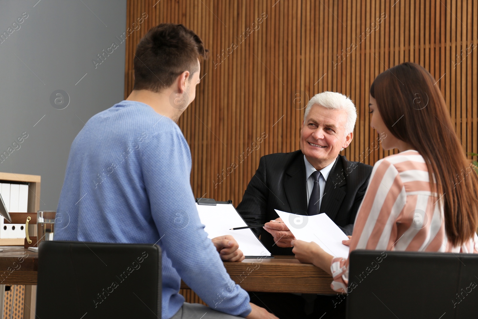 Photo of Lawyer having meeting with young couple in office