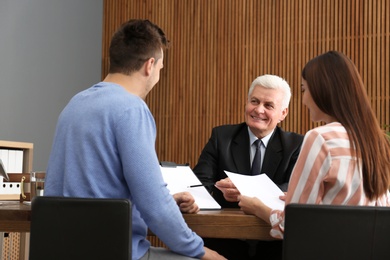 Lawyer having meeting with young couple in office