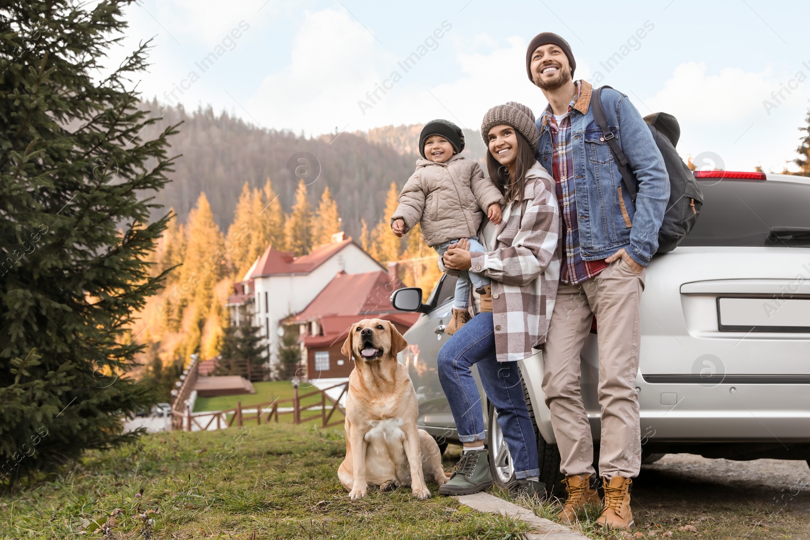 Photo of Parents, their daughter and dog near car in mountains, space for text. Family traveling with pet