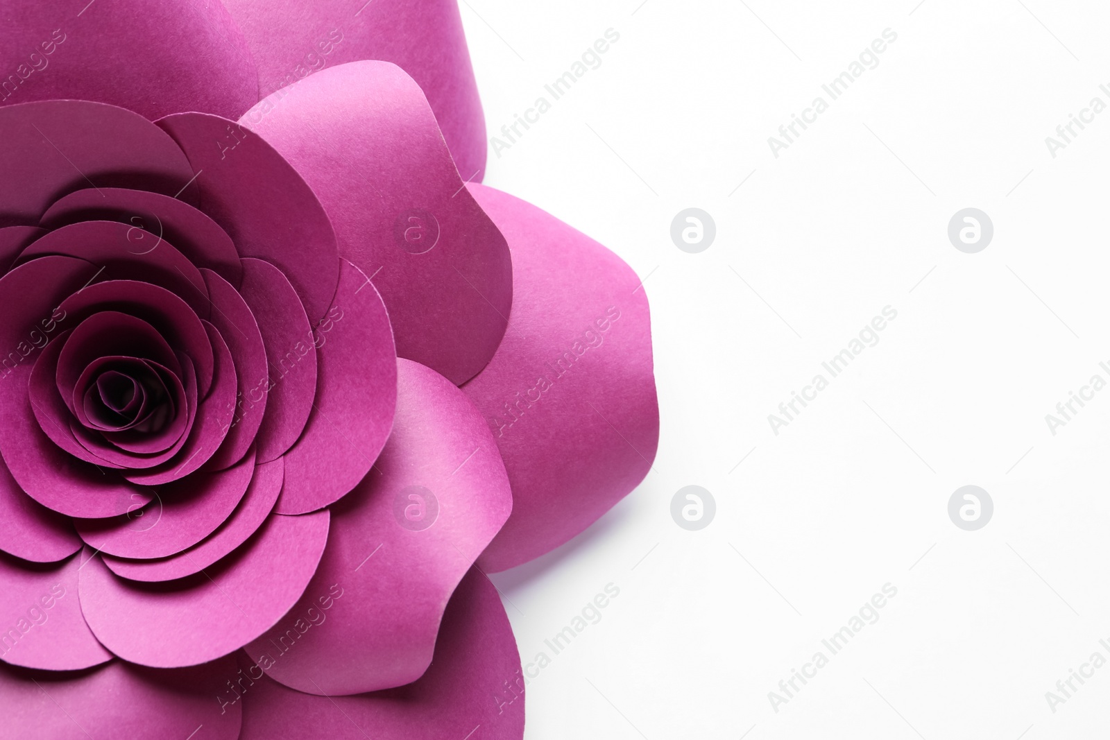 Photo of Beautiful pink flower made of paper on white background, top view