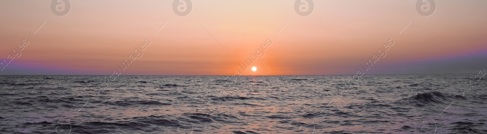 Image of Beautiful panorama of sky over sea at sunset. Banner design