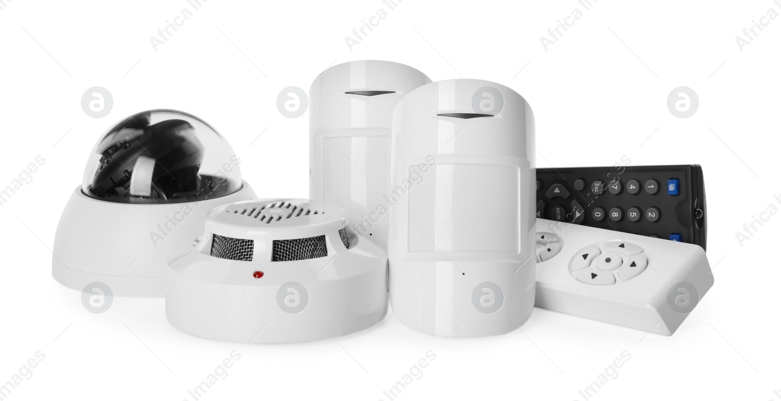 Photo of CCTV camera, remote controls, smoke and movement detectors on white background. Home security system