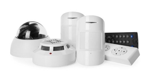 Photo of CCTV camera, remote controls, smoke and movement detectors on white background. Home security system