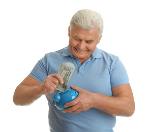 Photo of Happy senior man with cash money and piggybank on white background