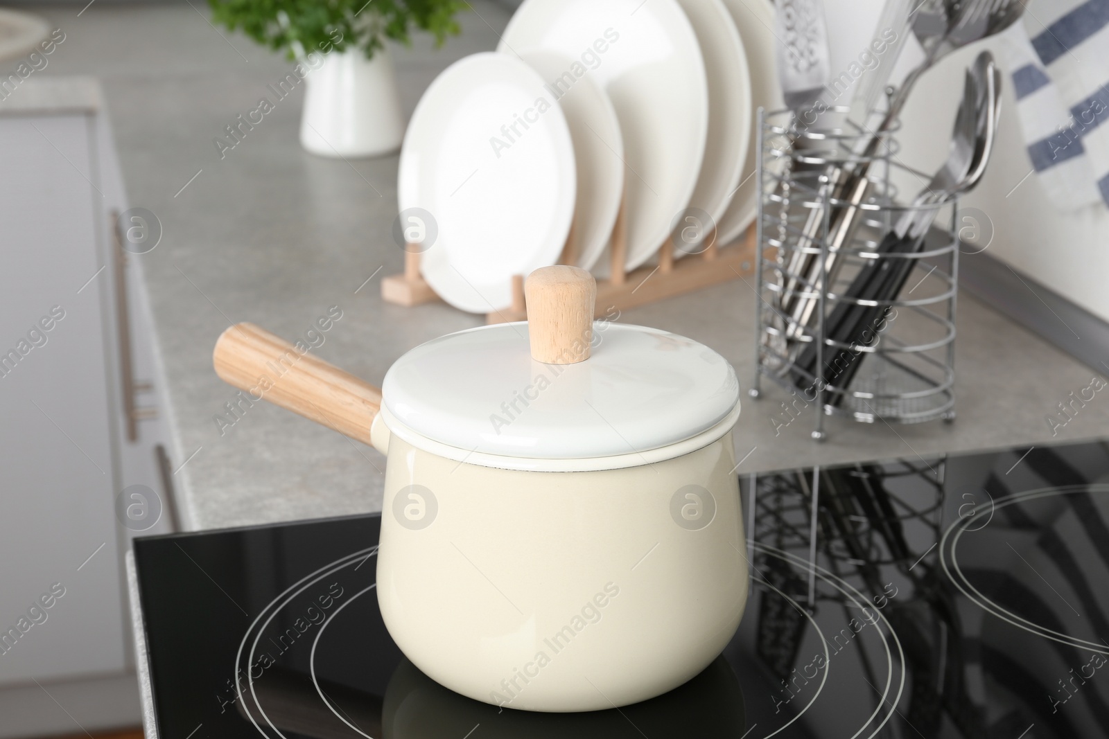 Photo of Pan on modern electric oven cooktop in kitchen