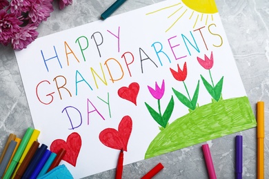 Beautiful drawing on grey marble table, flat lay. Happy Grandparents Day