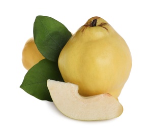 Photo of Whole and cut delicious quinces on white background