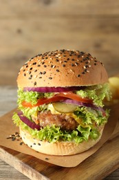 Photo of Burger with delicious patty on wooden table