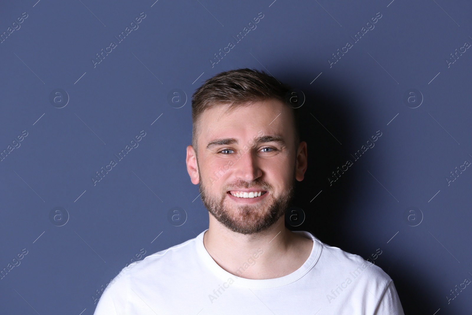 Photo of Portrait of handsome happy man on grey background