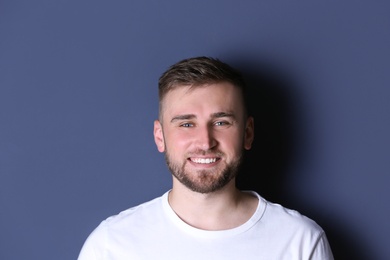 Photo of Portrait of handsome happy man on grey background