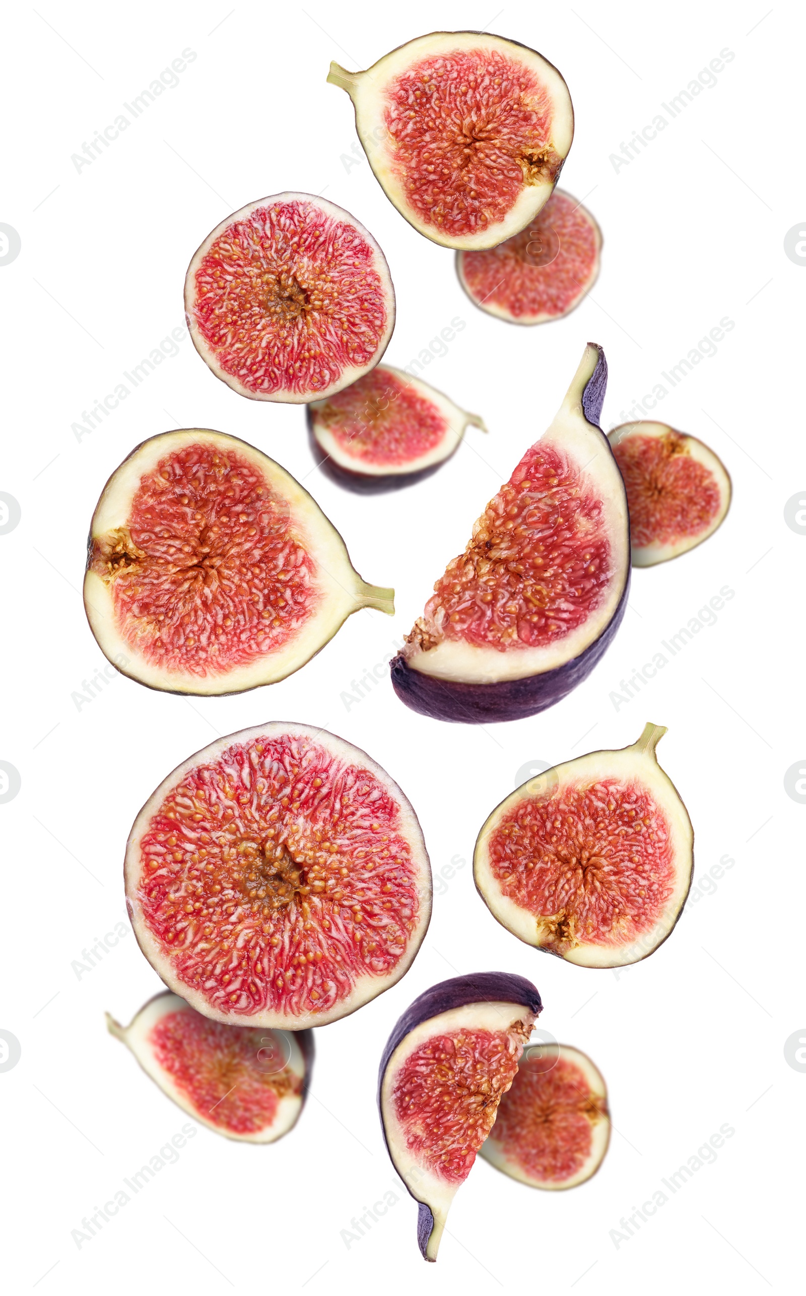 Image of Tasty ripe cut figs flying on white background