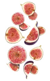 Tasty ripe cut figs flying on white background