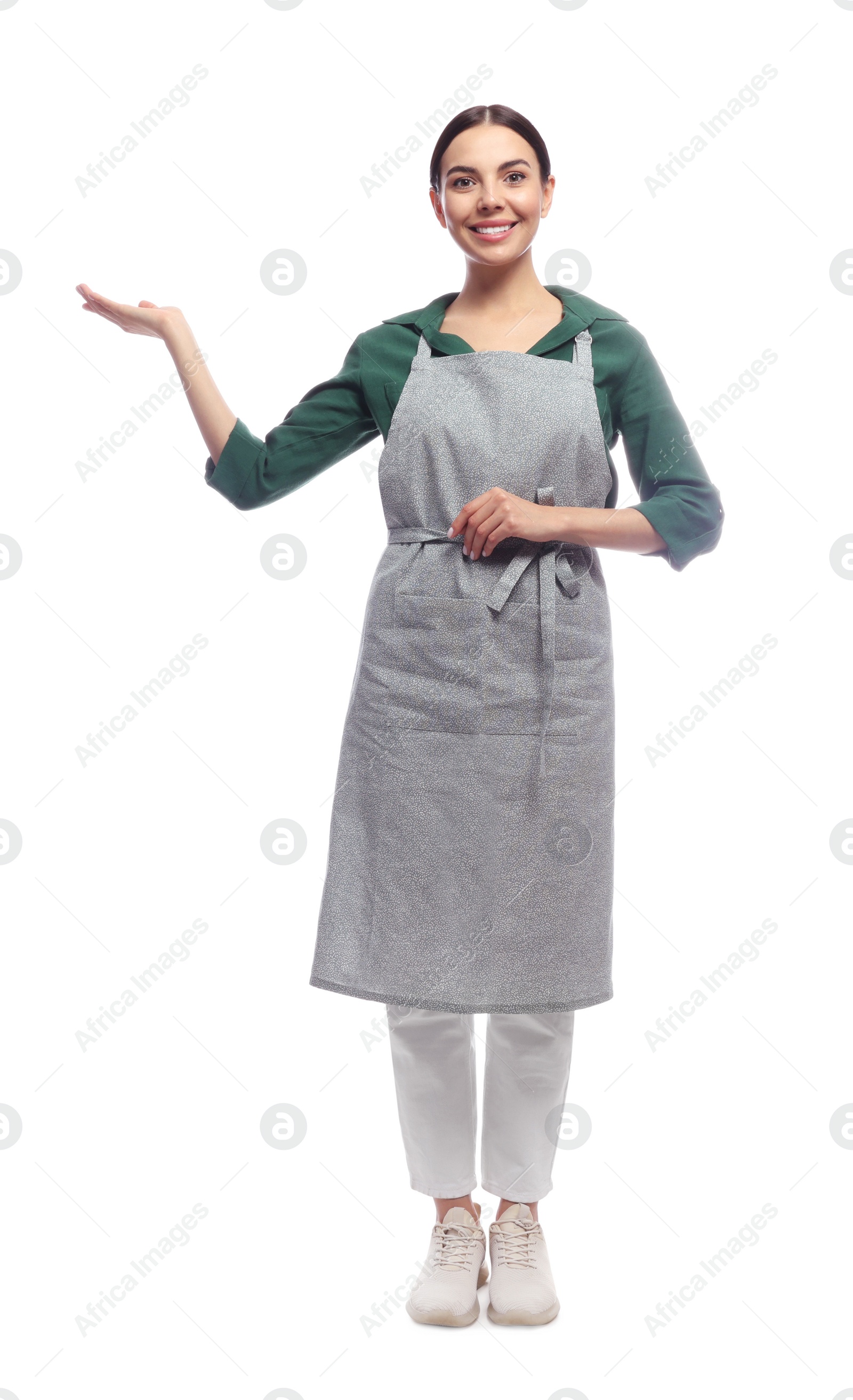 Photo of Young woman in grey apron on white background