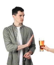 Photo of Man with car keys refusing alcohol while woman suggesting him beer on white background, closeup. Don't drink and drive concept