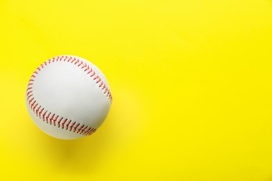 Photo of Baseball ball on yellow background, top view with space for text. Sports game