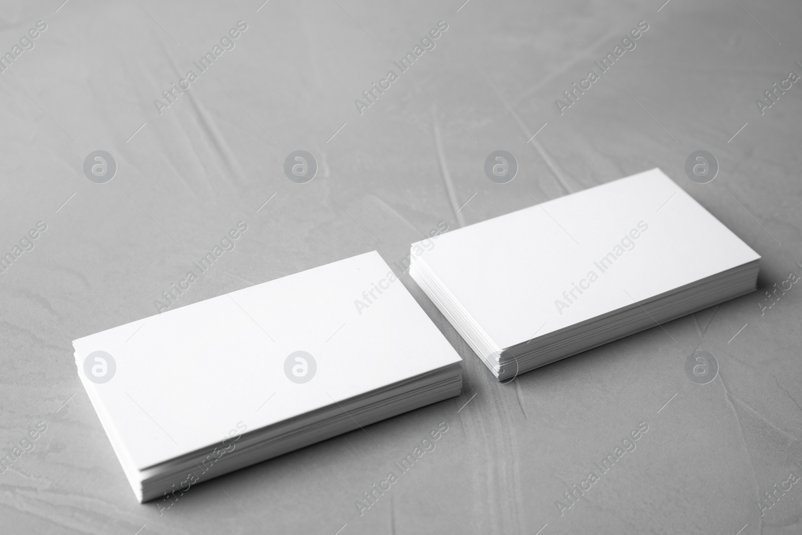 Photo of Blank business cards on light grey stone background. Mock up for design