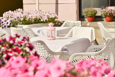 Outdoor cafe with beautiful flowers and comfortable furniture