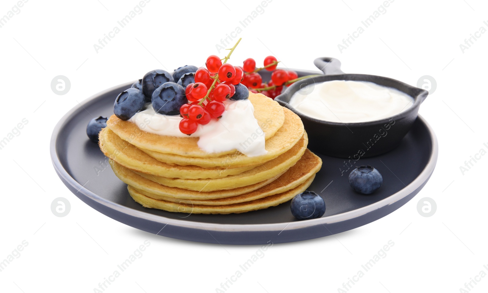 Photo of Tasty pancakes with natural yogurt, blueberries and red currants on white background