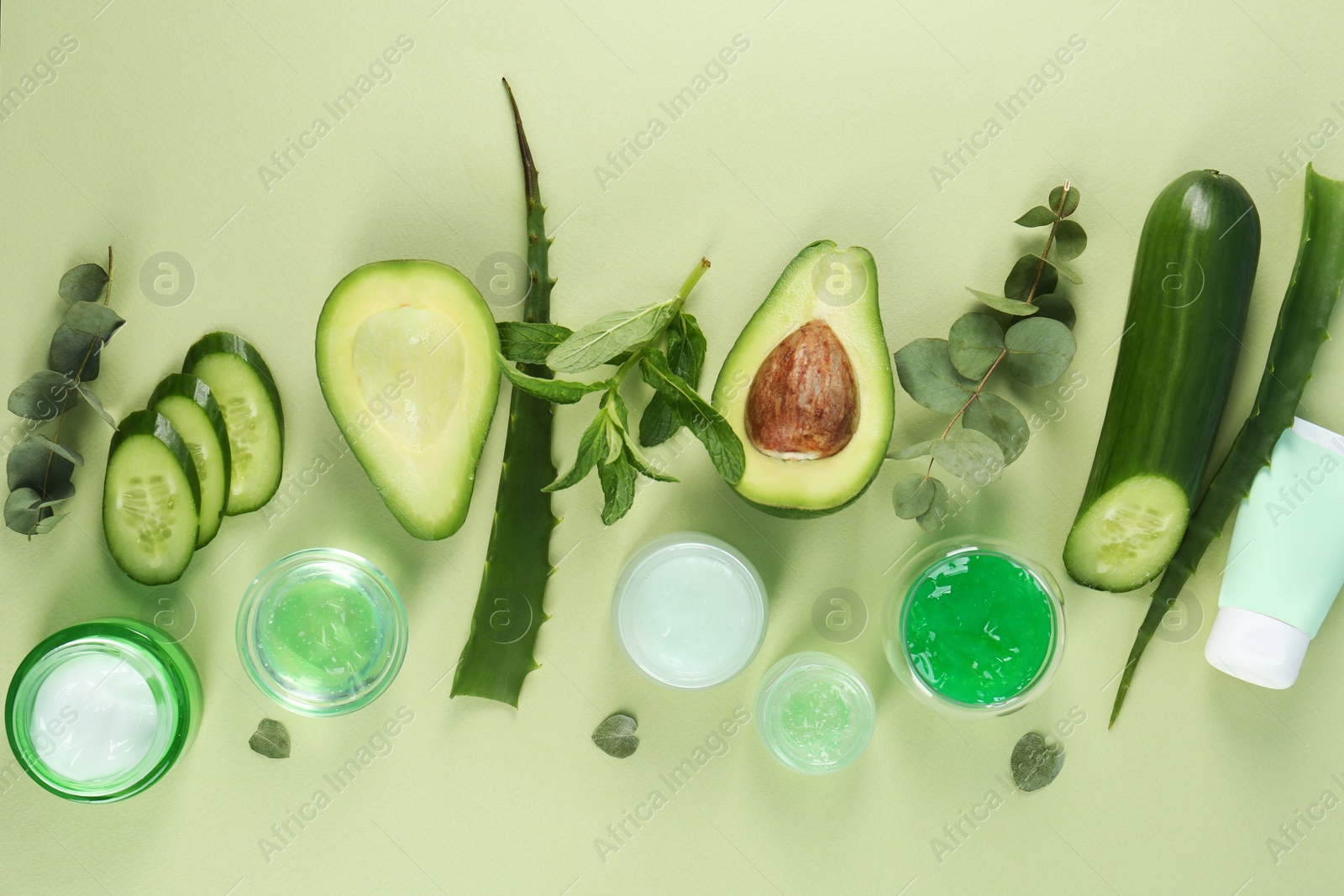 Photo of Flat lay composition with homemade cosmetic products and fresh ingredients on light green background. DIY beauty recipe