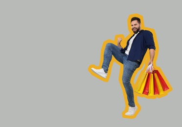 Image of Happy man with shopping bags on grey background, space for text