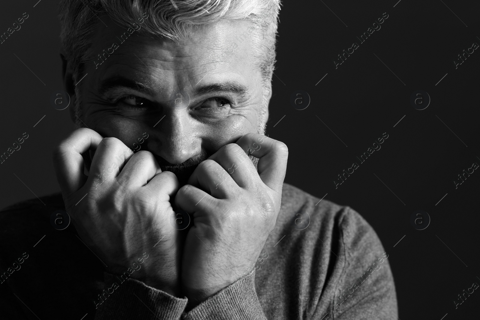 Photo of Portrait of handsome man on dark background, space for text. Black and white effect