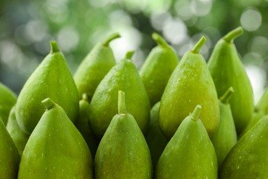 Photo of Many fresh green figs on blurred background, closeup