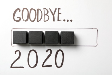 Text Goodbye 2020 and drawn loading line with cubes on white background, flat lay