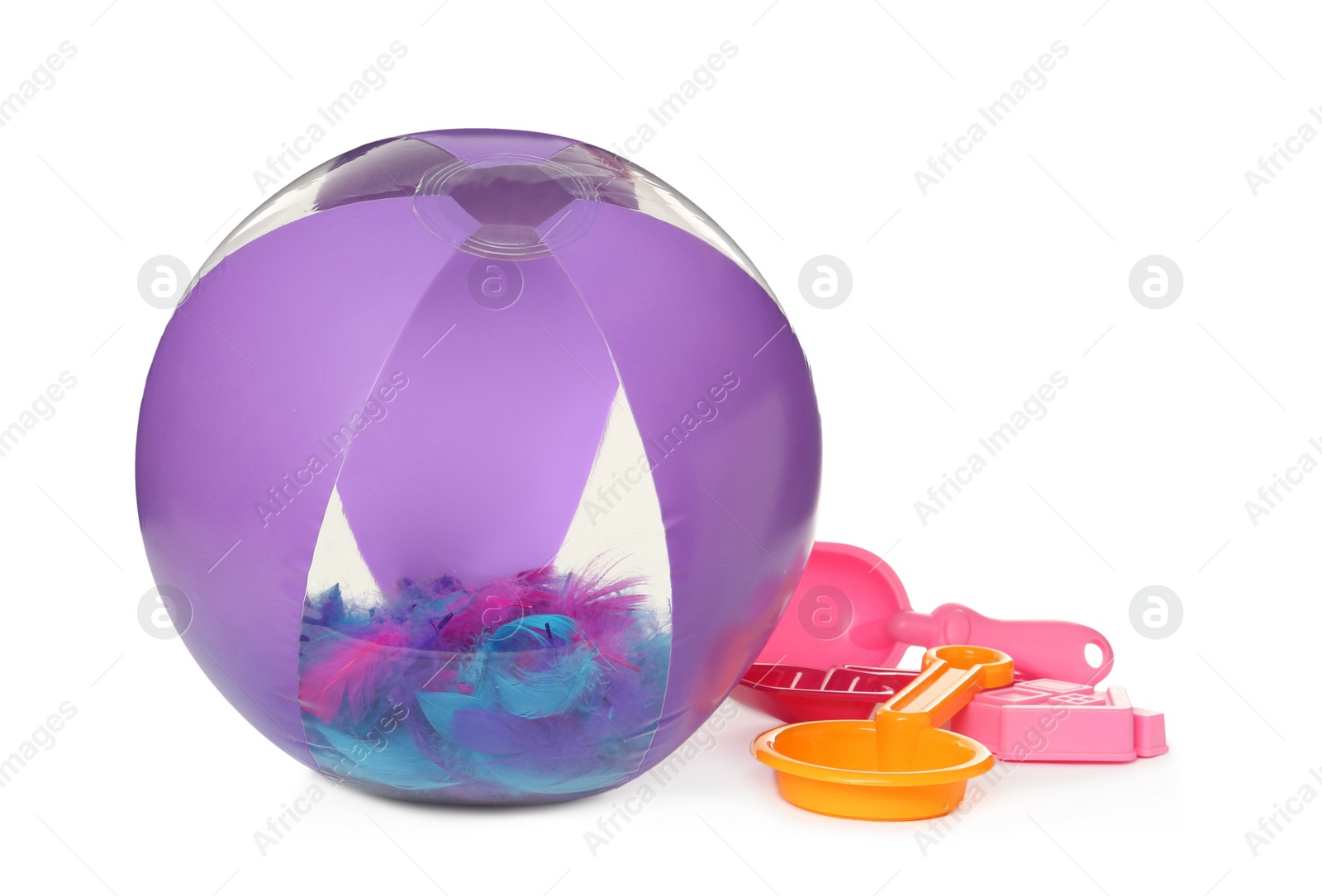 Photo of Inflatable beach ball and child plastic toys on white background