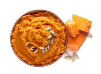 Photo of Delicious vegetable puree with pumpkin pieces and seeds on white background, top view. Healthy food