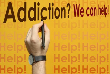 Image of Alcohol addiction? - We can help you. Closeup view of man with pen against yellow background