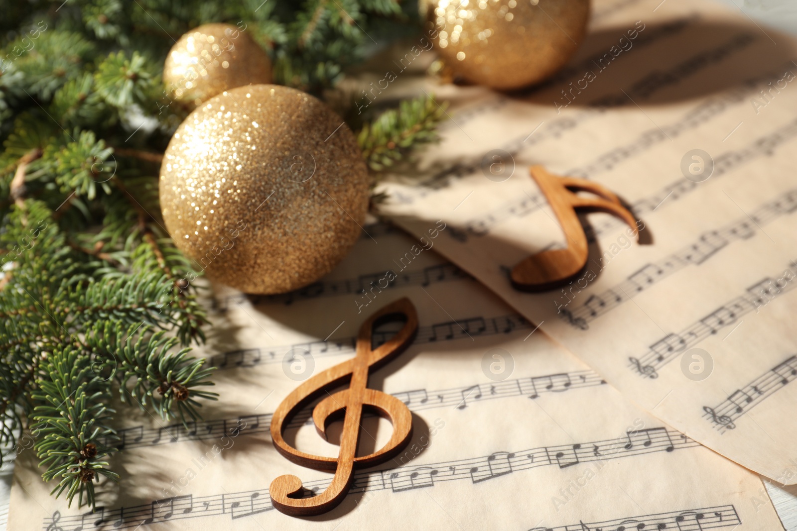 Photo of Composition with Christmas balls and wooden music notes on table