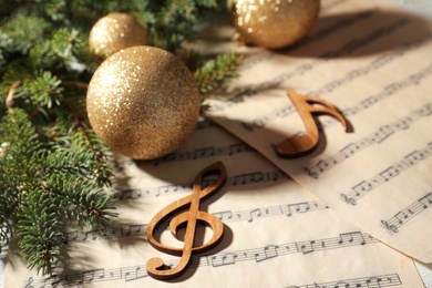 Photo of Composition with Christmas balls and wooden music notes on table