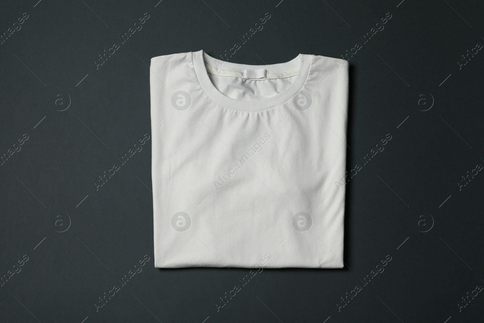 Photo of Stylish T-shirt on black background, top view