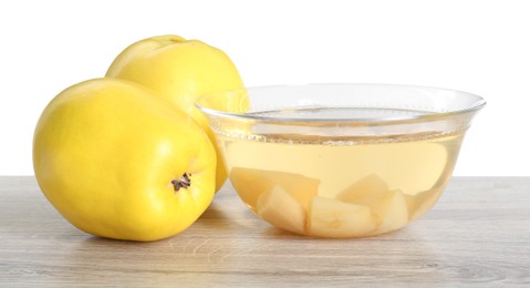 Delicious quince drink and fresh fruits on wooden table against white background