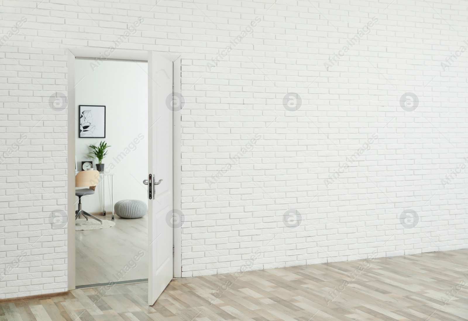 Photo of Stylish home office interior, view through open door. Space for text