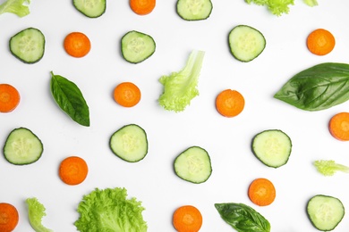 Photo of Fresh vegetables for salad on white background, top view