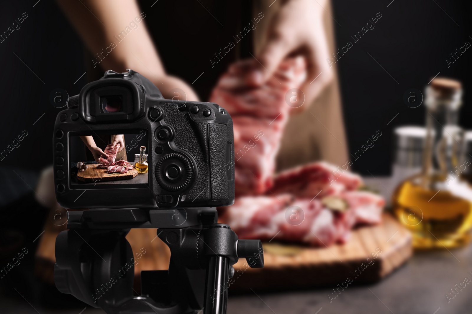 Image of Food photography. Shooting of man holding raw ribs, focus on camera