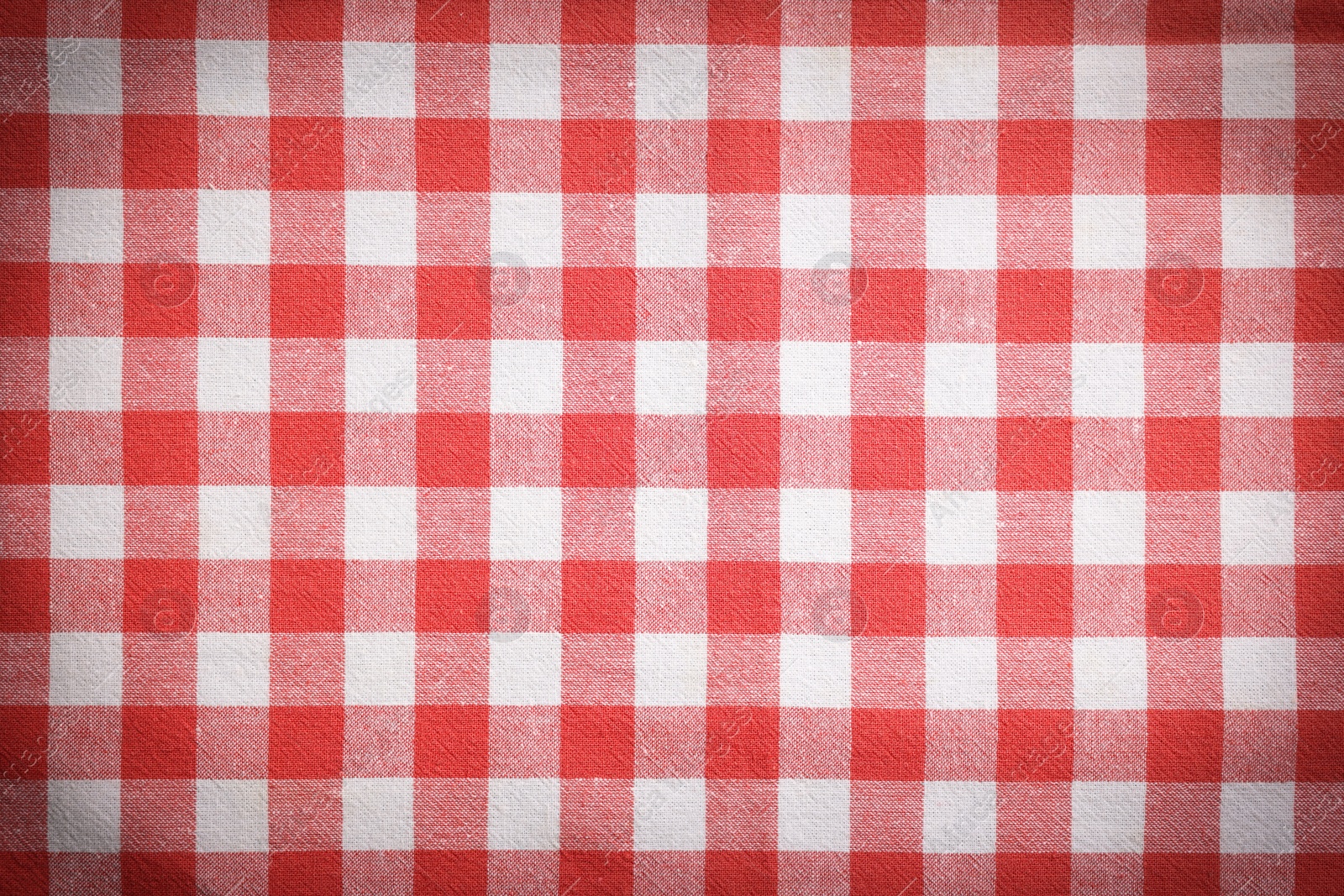 Image of Red and white tablecloth as background, vignette effect