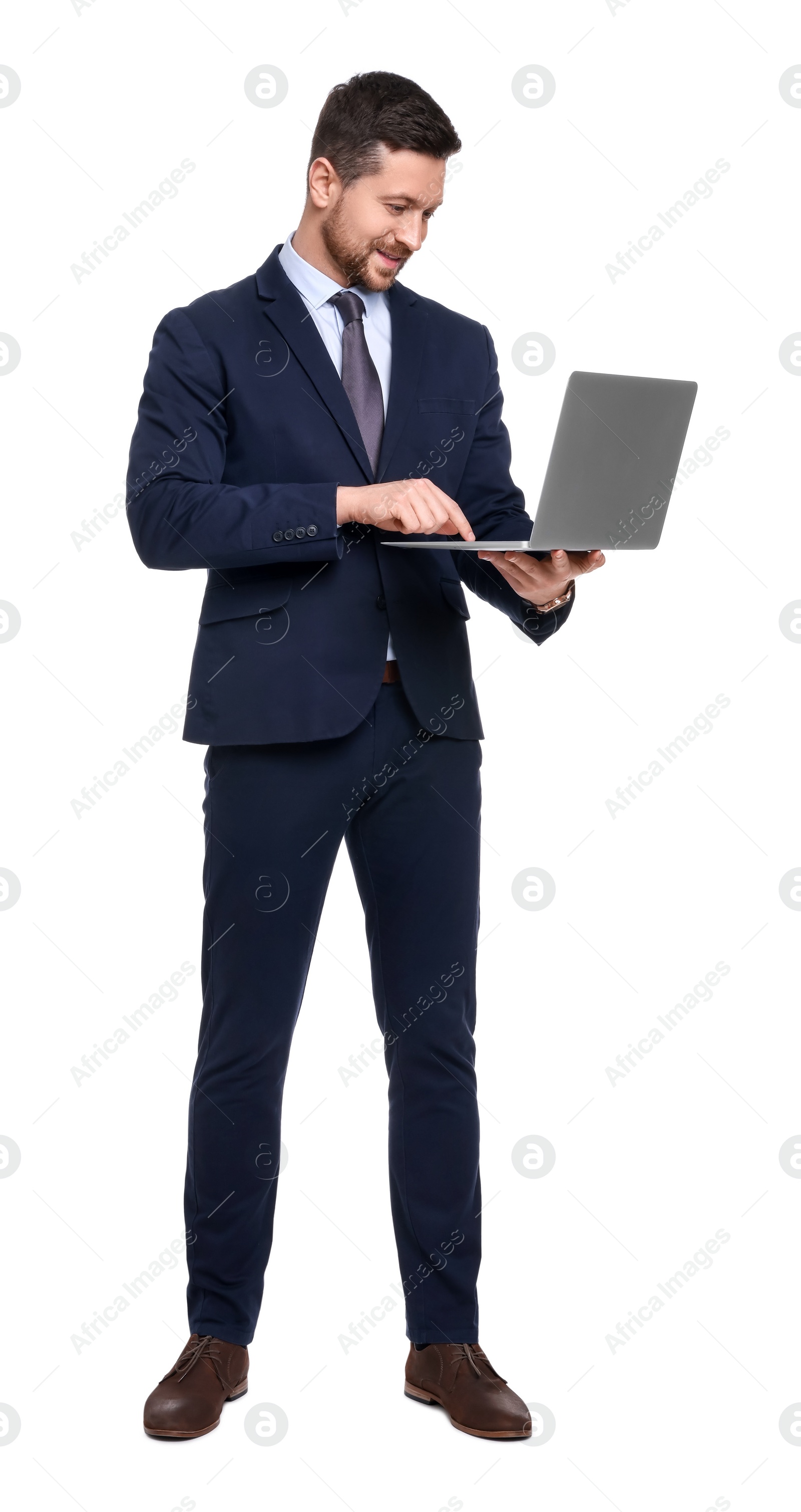 Photo of Handsome bearded businessman in suit with laptop on white background