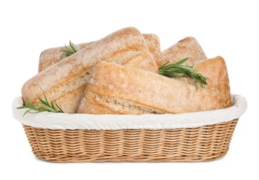 Photo of Crispy ciabattas with rosemary in wicker basket isolated on white. Fresh bread