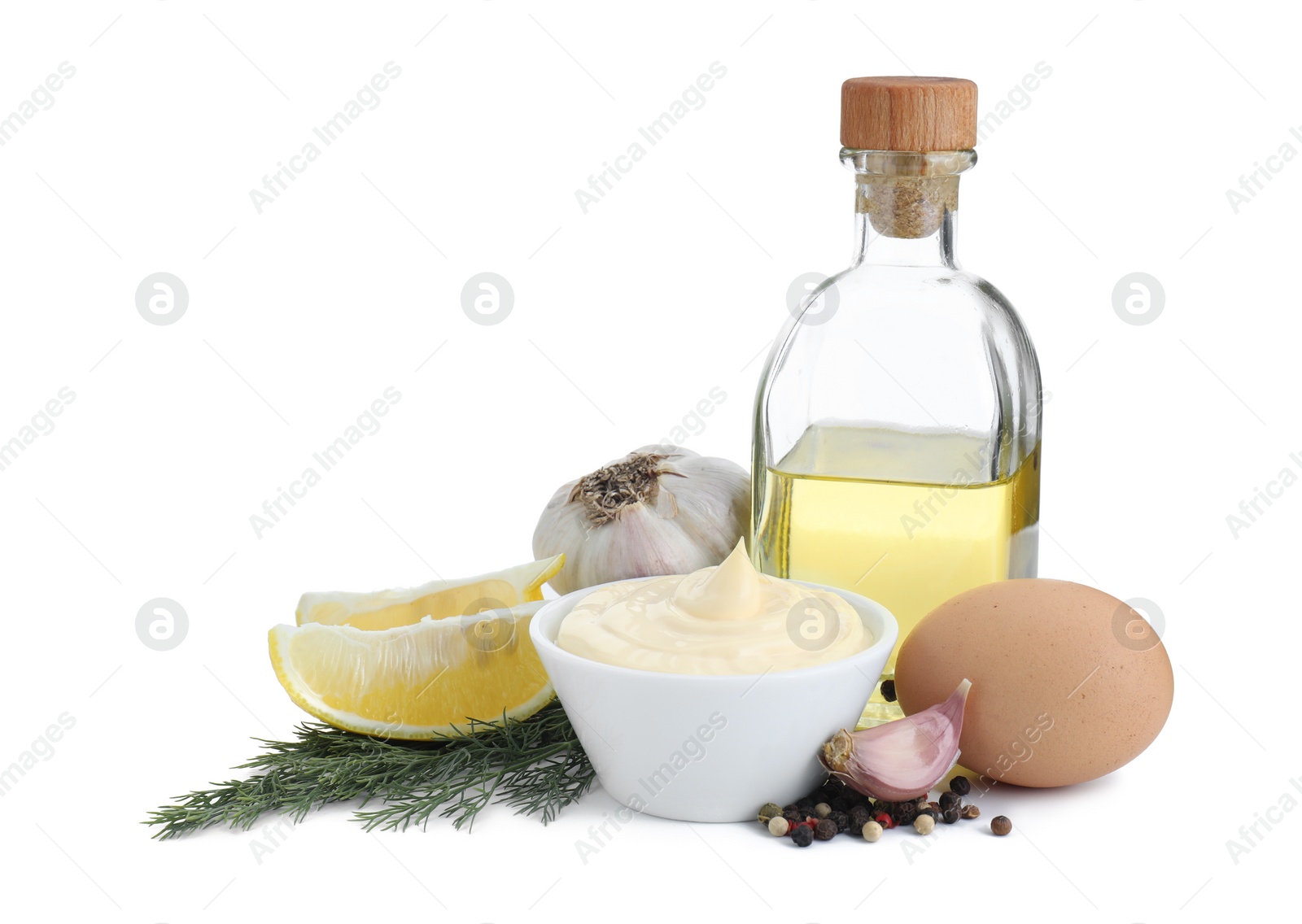 Photo of Fresh mayonnaise sauce in bowl and ingredients isolated on white