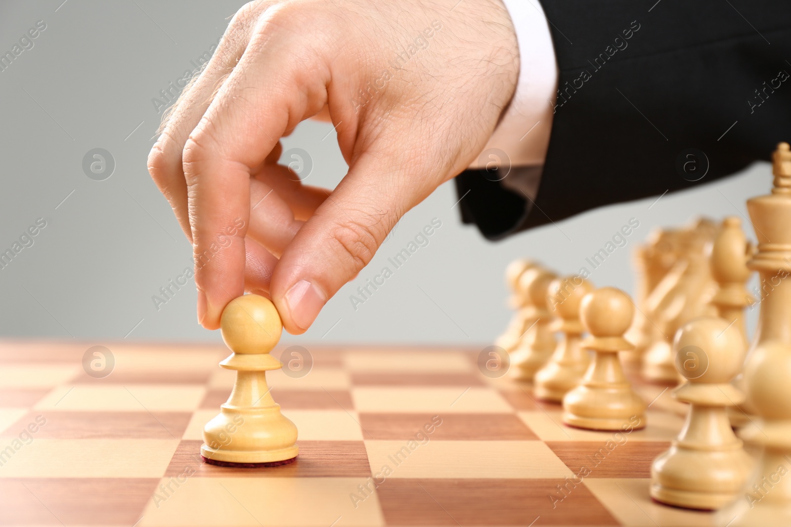 Photo of Man moving chess piece on board, closeup