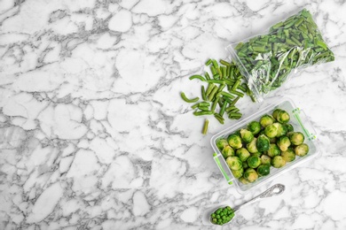 Photo of Different frozen vegetables on marble table, top view