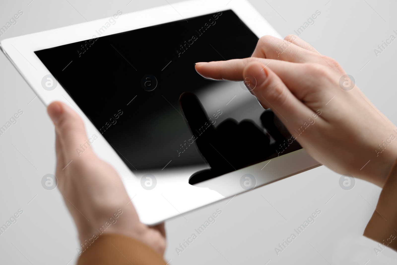 Photo of Closeup view of woman using modern tablet on light grey background