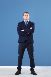 Business trainer standing on color wall background