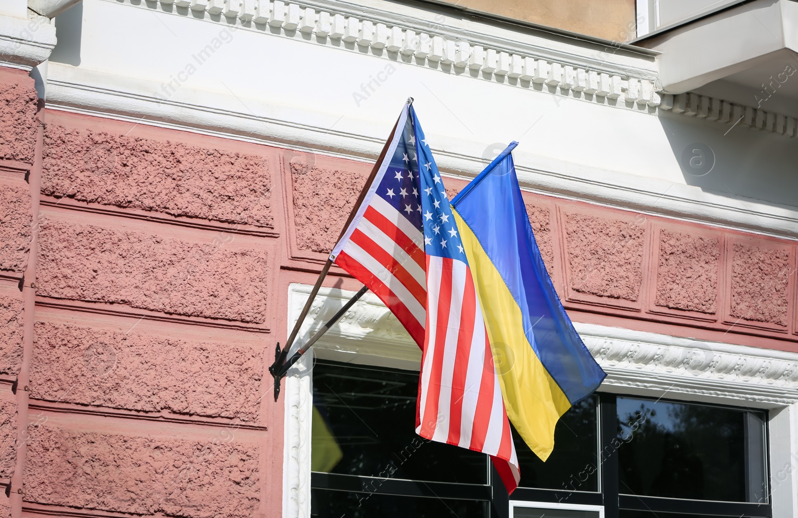 Photo of Flags of Ukraine and USA on building facade