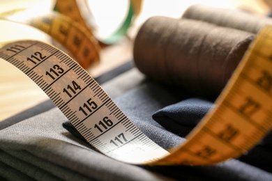 Photo of Measuring tape for tailoring on fabric, closeup