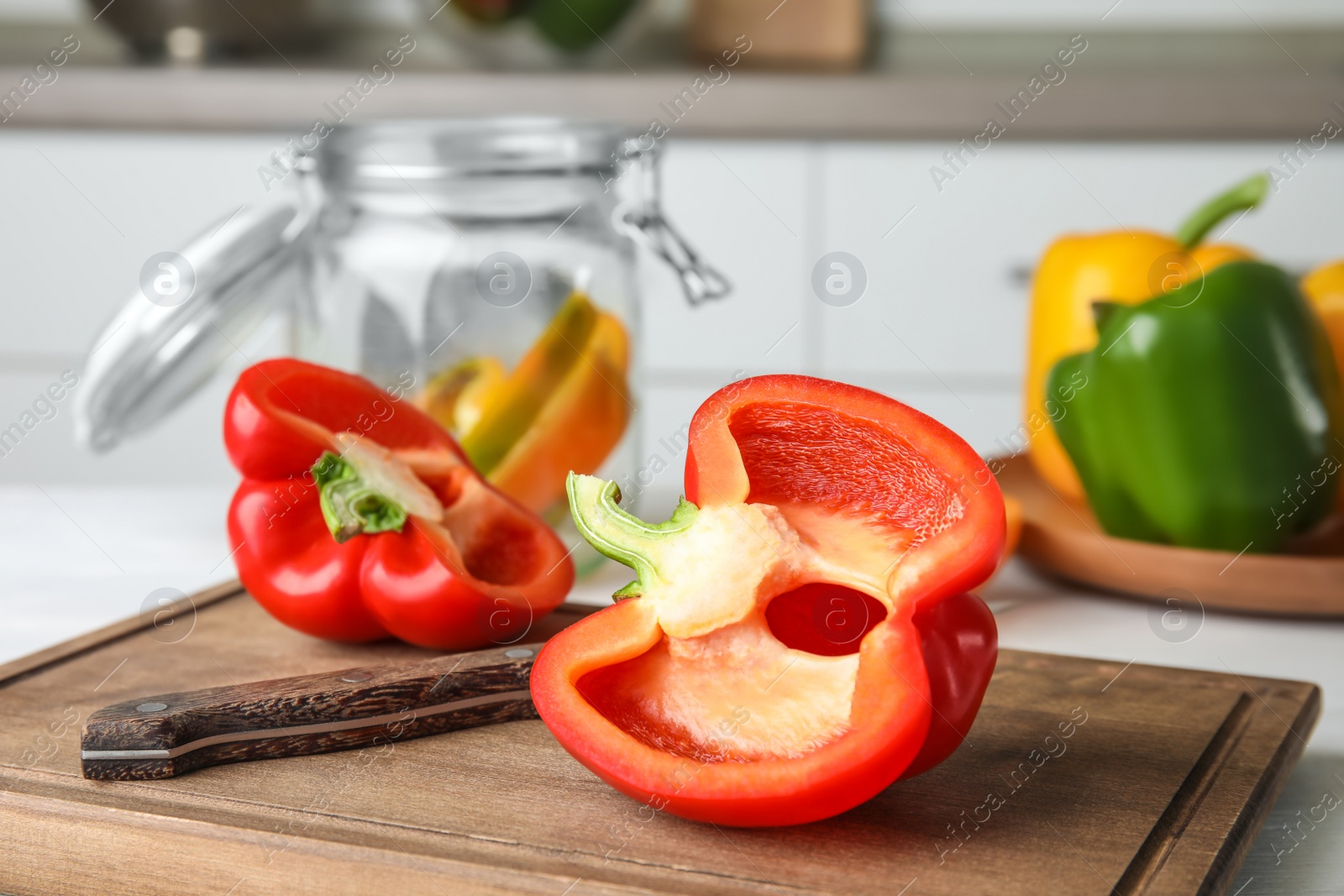 Photo of Wooden board with cut paprika pepper on table, closeup