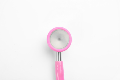 Photo of Pink stethoscope isolated on white, top view. Breast cancer awareness